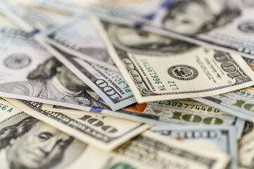 Money american hundred dollar bills.Closeup of assorted American banknotes.US currency scattered on the table.america currency dollor currency.World economic crisis associated with coronovirus.