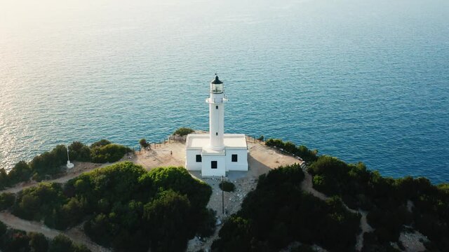 Aerial zoom in shot of Cape of Ducato, famous lighthouse at Lefkada island of Greece.
