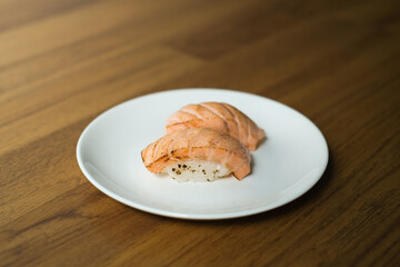 Grilled or burned salmon sushi on white plate, Japanese Food Style