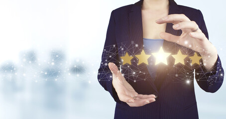 Review, Rating,Satisfaction. Two hand holding virtual holographic five stars icon with light...