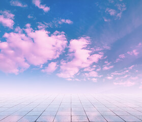 pink clouds, blue sky, gray floor.