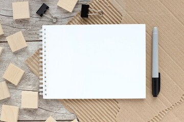 Workspace with pen, notepad with place to insert text on a wooden table. Business concept. Copy space