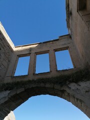 Fototapeta premium old archway with three windows in colour