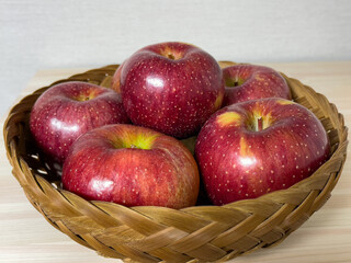 red apples in a bamboo basket