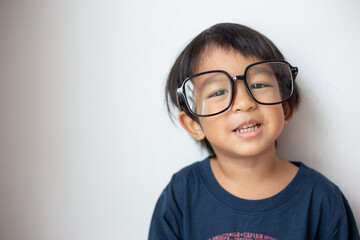 Happy facial face of little boy with big glasses on white background