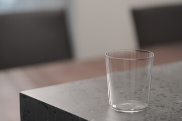 thin tumbler glass on concrete countertop with copy space