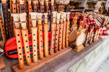The assortment of duduk for sale on the shelves of the souvenir shop. Traditional Armenian brass musical instrument made of Apricot wood