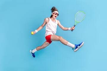 Fototapeta na wymiar Full length body size photo man jumping up playing tennis on court isolated pastel blue color background