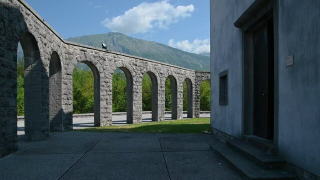 Italian ossuary in Kobarid, Slovenia. Military cemetery charnel house. Monument in memory of fallen Italian soldiers. Church of St. Anton on the top. Left pan
