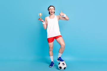 Full length body size photo male athlete keeping golden champion cup showing like isolated pastel blue color background