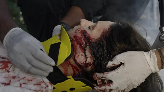 Workers of emergency service rescuing victim in car accident