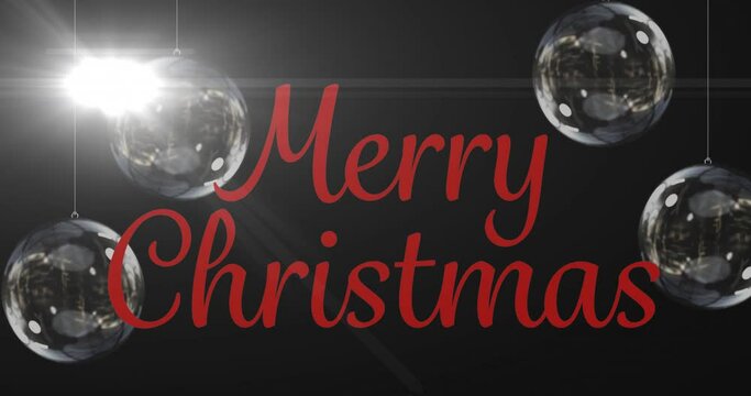 Animation of merry christmas text over baubles
