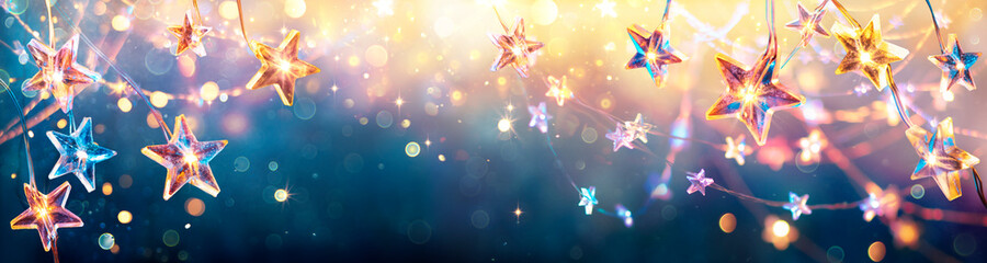 Christmas Stars With Golden Lights Hanging In Blue Background - String With Abstract Defocused Bokeh