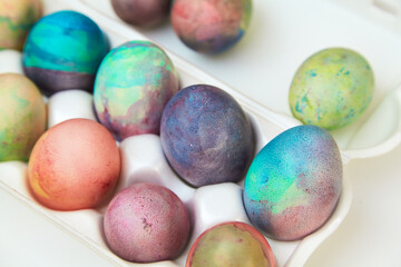 Group of Easter painted eggs in white container
