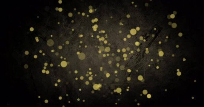 Animation of golden dots falling on black background