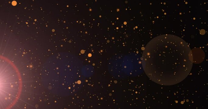 Animation of sunrays and golden dots falling on black background