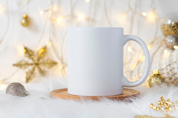 Obraz na płótnie Canvas Imprint mockup white ceramic coffee mug on cozy Christmas background with copy space for your design. Standard 11 oz mug for branding and souvenirs