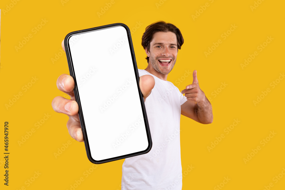 Poster man pointing at white empty smartphone screen, mockup