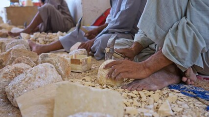 master works with the stone in the old way