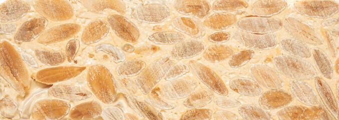 Nougat Turron Almond nuts as a  Background with texture. Tourron Wallpaper. Top view.