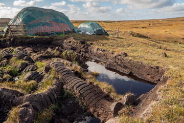 Peat bog production in Ireland for household heating needs. Warm sunny day, blue sky. Nobody. Traditional craft and energy source
