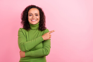 Obraz premium Photo of pretty cute african lady dressed green turtleneck smiling pointing finger empty space isolated pink color background