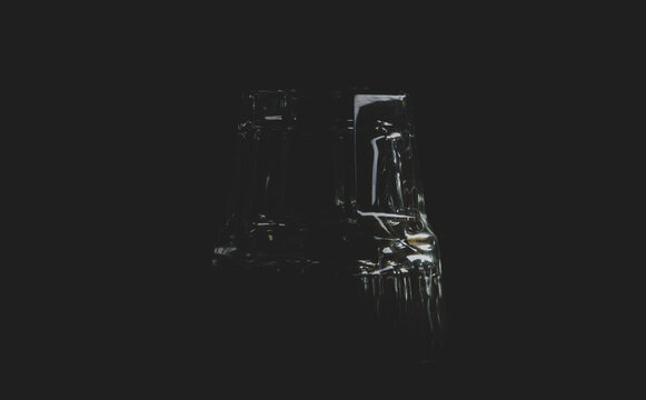 glass for whiskey on black matte background