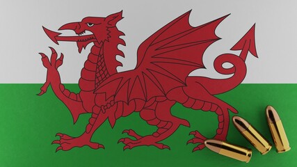 Fototapeta premium Three 9mm bullets on the bottom right corner on top of the flag of Wales