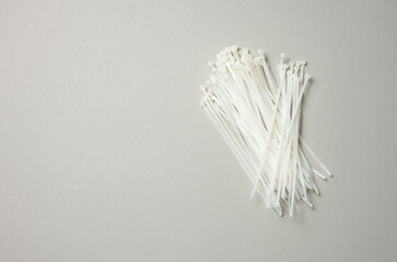 stack of plastic cable ties on gray background. View from above