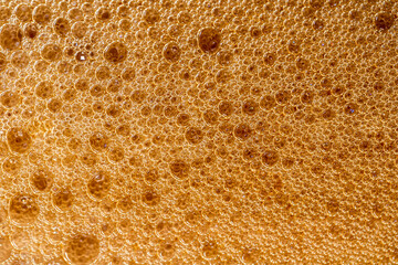 beer foam texture close up , porous ale bubble background macro , colored bar lager backdrop