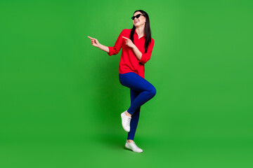 Fototapeta na wymiar Full length body size view of attractive lucky cheerful lady demonstrating copy space ad solution isolated over bright green color background