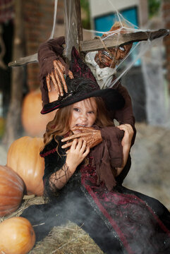 witch girl holiday Halloween depicts the bite of a witch in a witch costume with a zombie in a shopping center