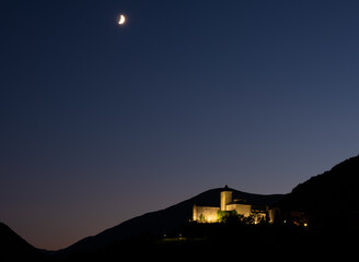 Fototapeta na wymiar The moon over Torla at sunset, Huesca, Spain.