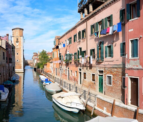 Washing lines along canal in Venice, Italy. Laundry hanging on a clothes line between city...