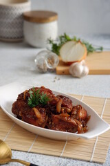 a plate of chicken cooked in butter sauce