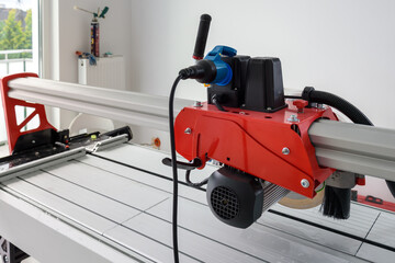 Cutter machine for ceramic tiles. A flat during renovation.