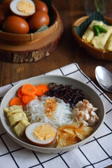 a bowl of vegetable and chicken soup on the table