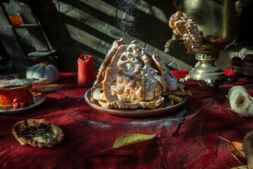 Halloween party brushwood. Traditional Russian crispy biscuits with powdered sugar.