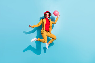 Fototapeta na wymiar Full length body size view of attractive cheerful girl jumping holding helium ball isolated over bright blue color background
