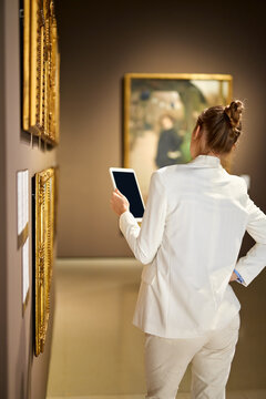 Woman visitor in the historical museum looking at pictures