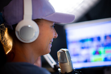 Beautiful Woman In A Cap And White Headphones Leads A Live Stream