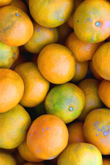 Wooden crate filled with fresh tangerines. Top view.