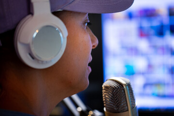 Beautiful Woman In A Cap And White Headphones Leads A Live Stream