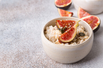 Oatmeal porridge with figs and seeds. Healthy breakfast food.