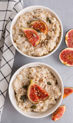 Oatmeal porridge with figs and seeds. Healthy breakfast food.
