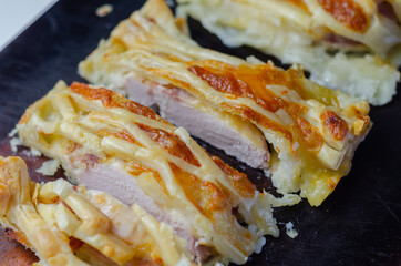 Chicken en croute, chicken breast inner fillets with mature cheddar cheese and beechwood smoked streaky bacon in a puff pastry lattice