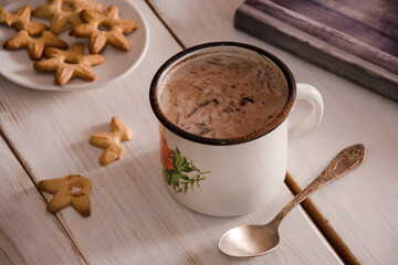 Cup of coffee and book on wooden table. 