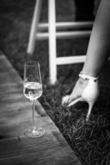 white wine glass and female leg in white shoe, monochrome photo © kavoons