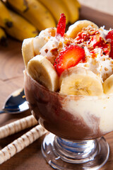 Beautiful ice cream bowl decorated with strawberries, bananas, chestnuts and whipped cream