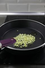 Making a sauce with olive oil, garlic